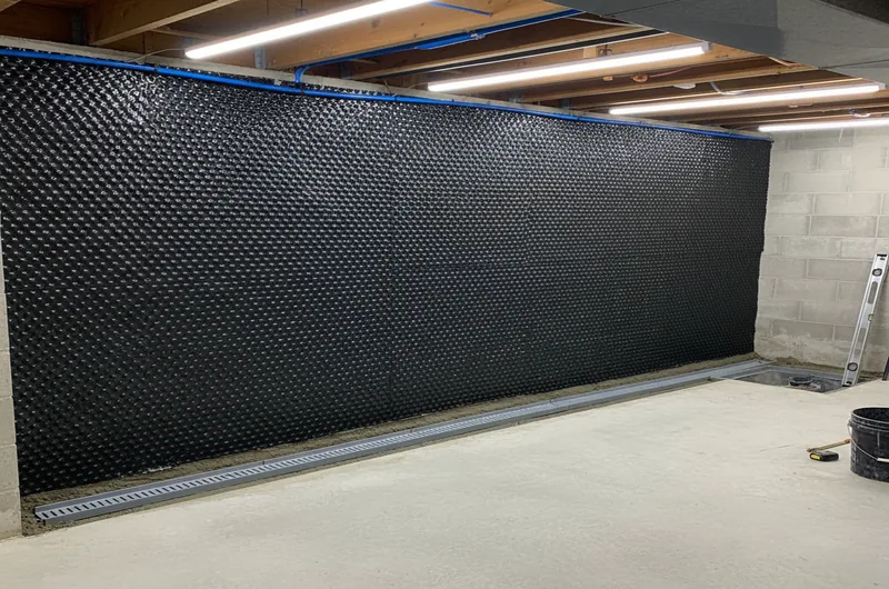 Diagram comparing interior drainage channel and exterior excavation waterproofing approaches
